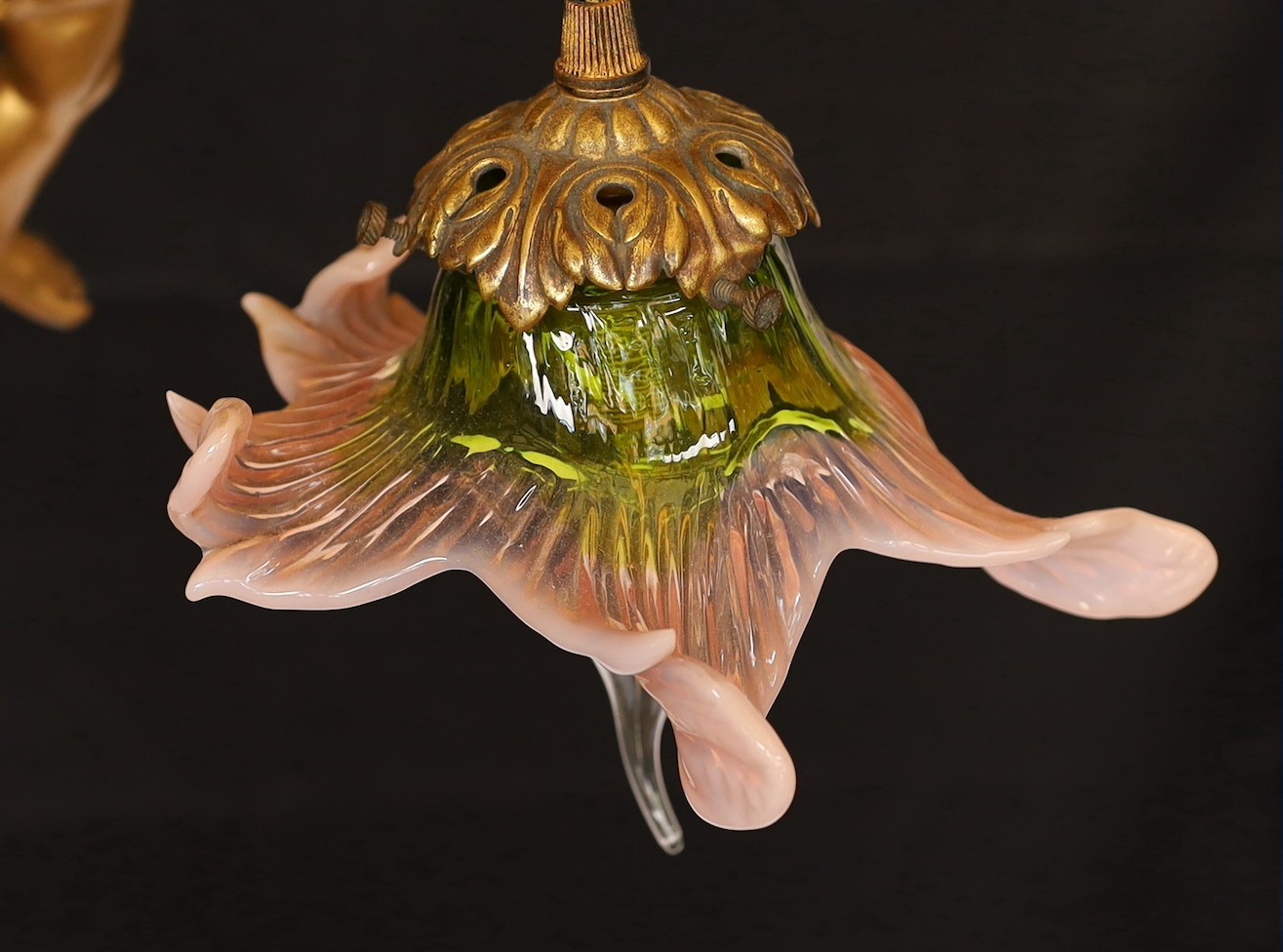A 1920s English gold painted spelter Cupid light fitting with coloured glass shade, height 54cm. width 24cm